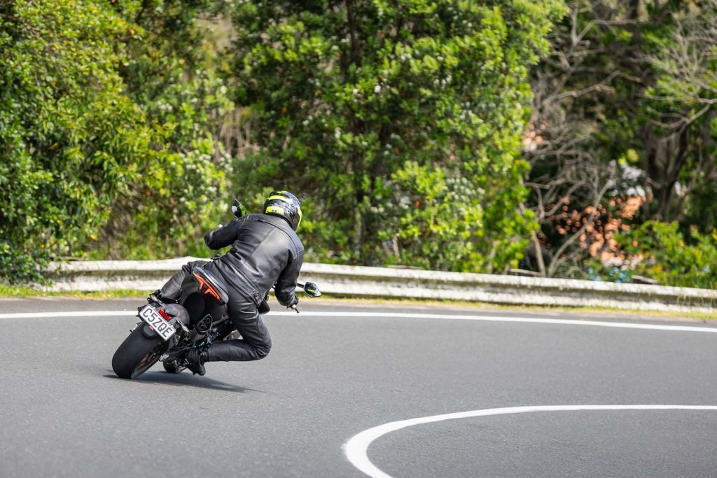 CFMOTO leaning into a corner, shown from the rear