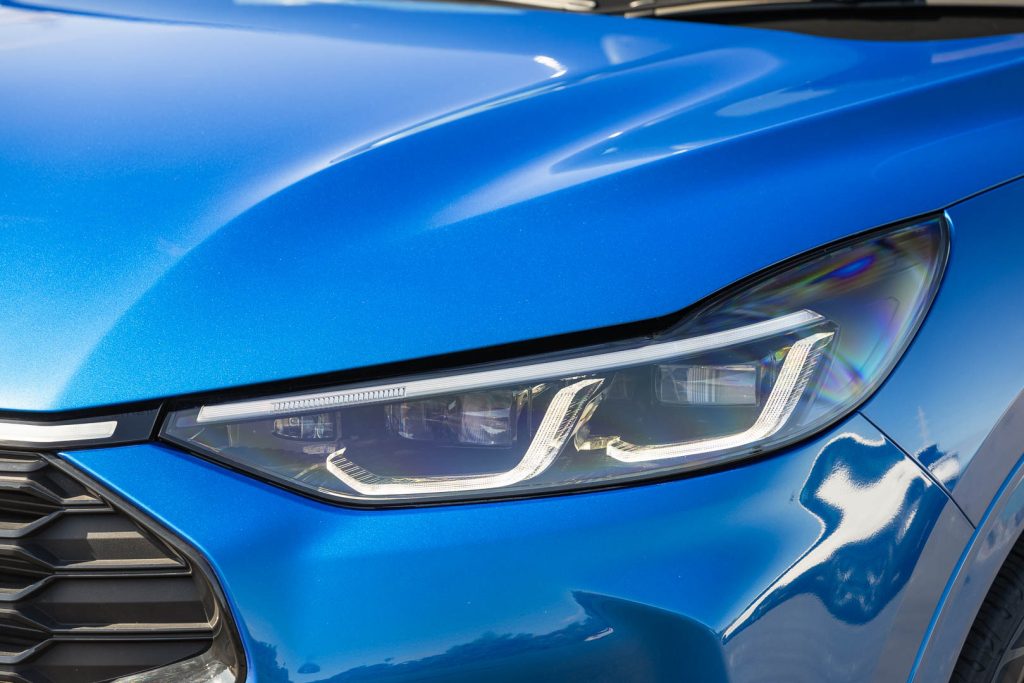 Blue Ford Escape, headlight detail showing LEDs