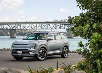 Kia EV5 light+ front quarter shot, with Auckland harbour bridge showing behind