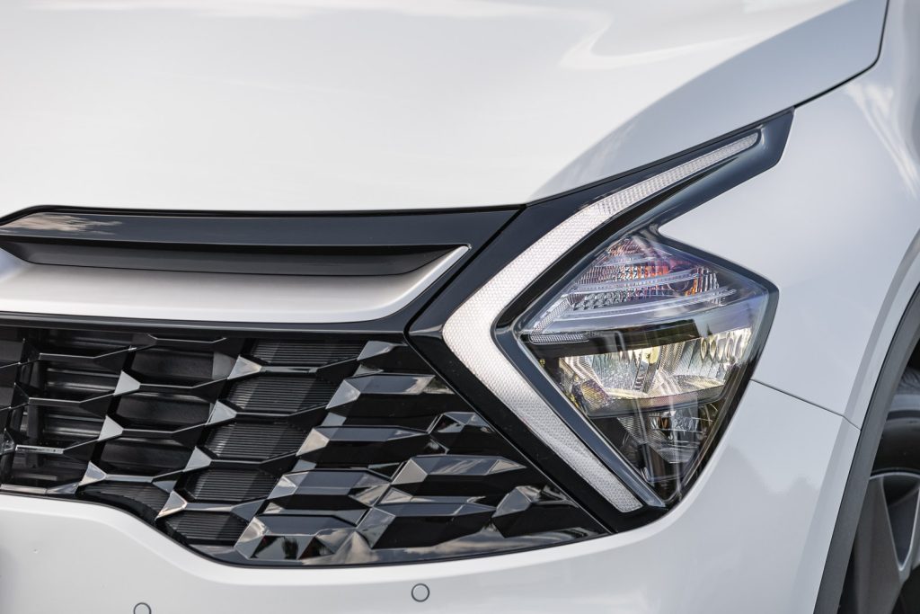 Headlight detail of the Kia Sportage, in white