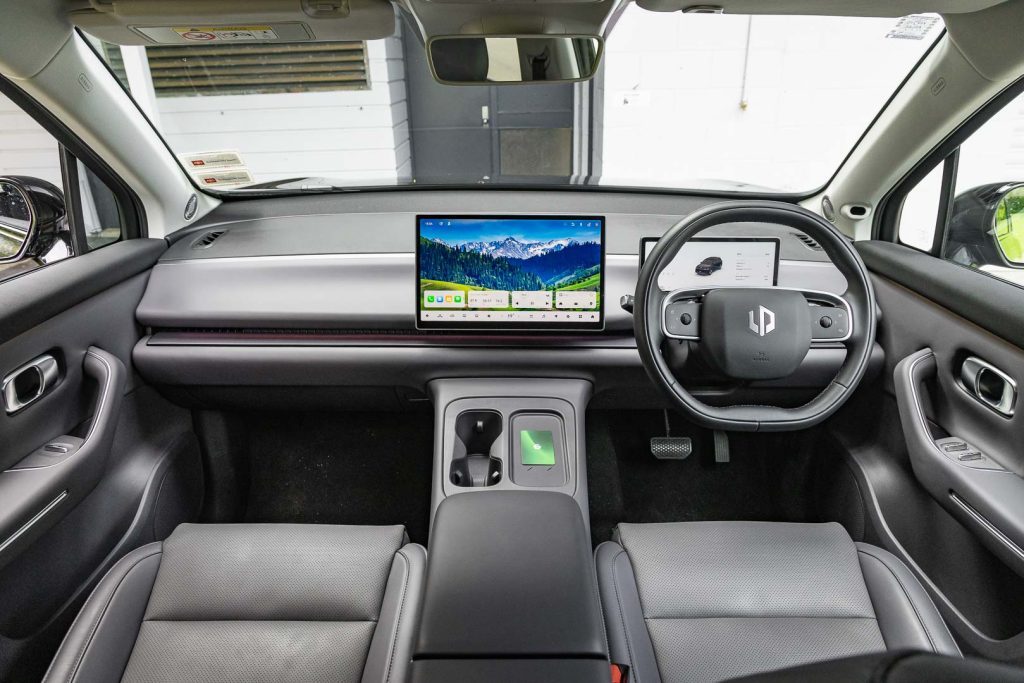 Wide interior view showing steering wheel, infotainment screen, etc