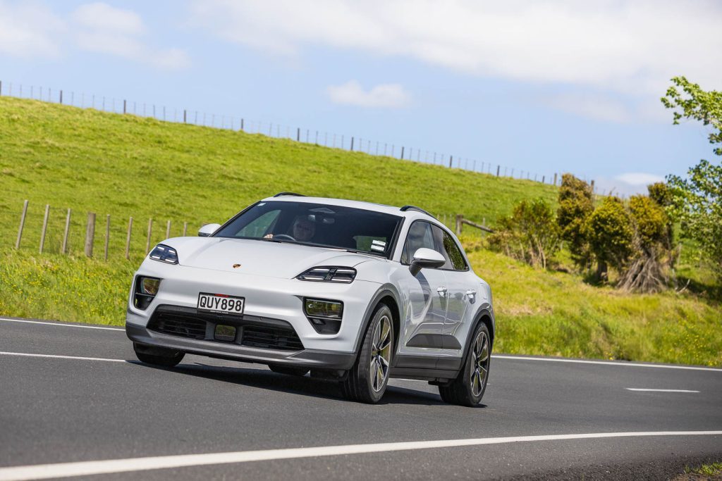 Cornering shot of the Porsche Macan 2024 EV. front view with LED matrix headlights