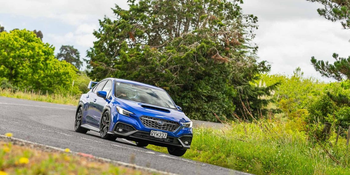 Cornering in a blue Subaru WRX Todoroki edition