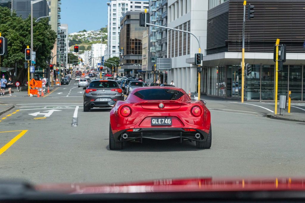 Alfa Romeo 4C in red, driving in Wellington