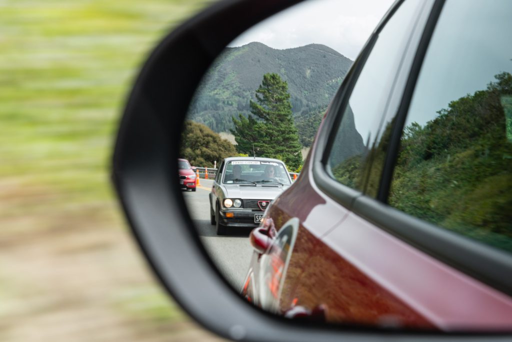 Alfa trailing behind in rear view mirror