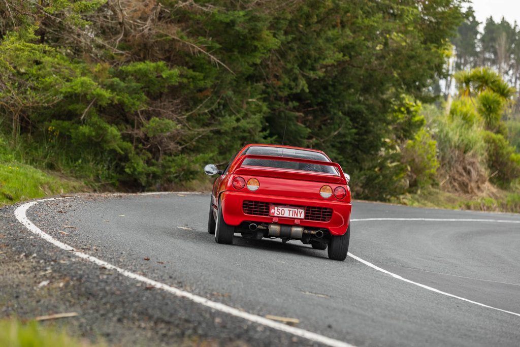 Rear view of Suzuki Cara or Autozam AZ-1 cornering, with round tail lights