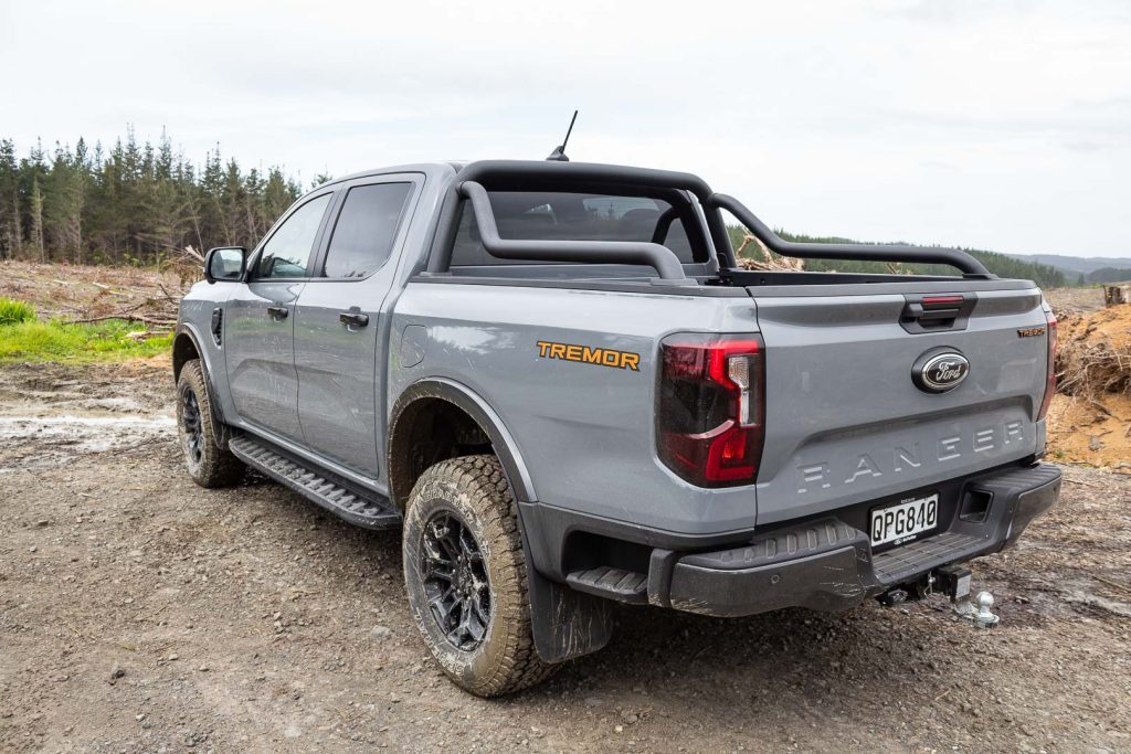 Rear quarter of the 2024 Ford Ranger Tremor. Parked on gravel with mud around