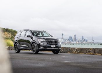 Mahindra XUV700 AX7L in black, parked in front of Auckland's skyline