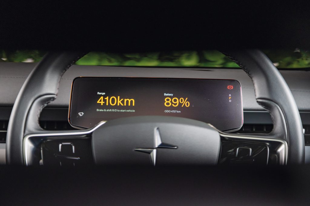 The driver's view of a Polestar 3 digital dashboard display, showing range, battery status, odometer, and gear indicators