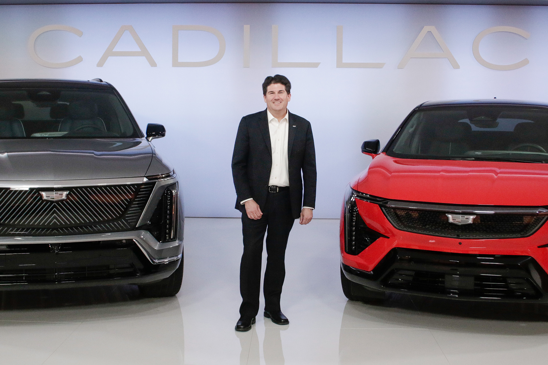 John standing next to a couple of Cadillacs that are coming to NZ