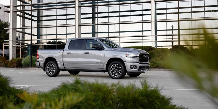 MY25 RAM 1500 in silver parked in front of a building