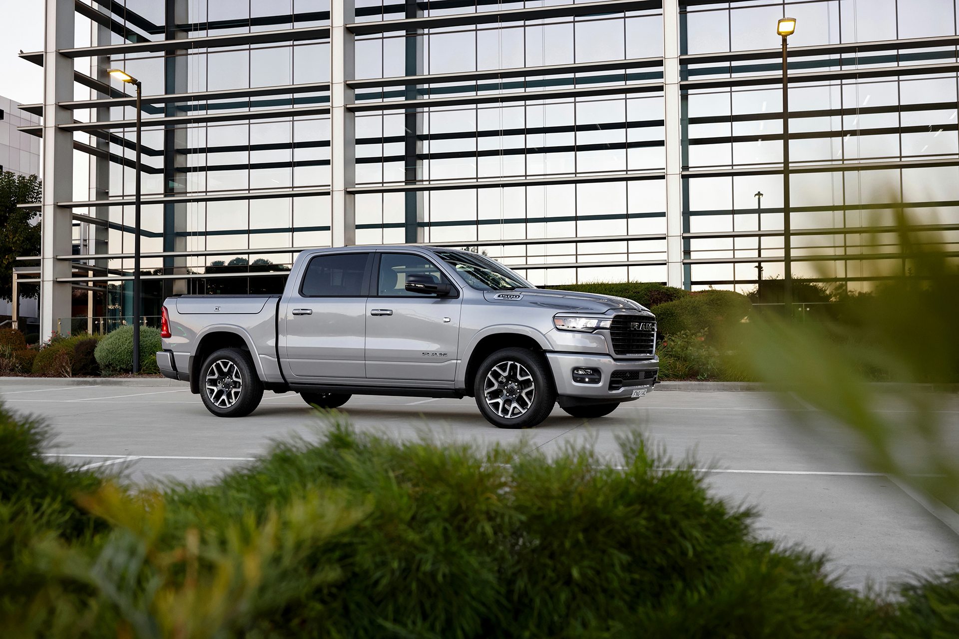 MY25 RAM 1500 in silver parked in front of a building